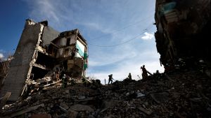 Rescuers work among remains of residential building destroyed by Russian shelling