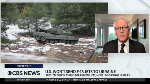 Screenshot of Ivo Daalder on CBS News at right, footage of tank at left