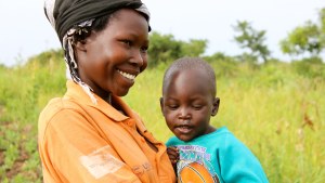 Esther smiles as she holds her son Rodgers.