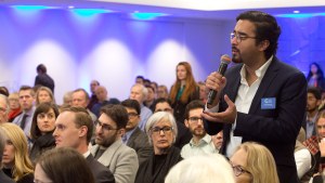 A member talks into a microphone during an event