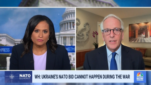 Kristen Welker left in a black blazer and lavender top; Ivo Daalder at right in a blue tie and black suit.