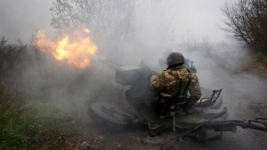 Ukrainian National guard soldiers fire at Russian positions from an anti-aircraft gun 