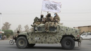 Taliban fighters patrol on the road