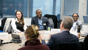 A group of Emerging Leaders sit around a table.