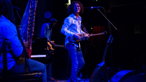 A guitar player performs on-stage