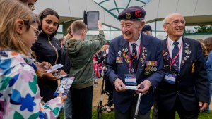 British World War II veteran John King is greeted by a young girl in Normandy