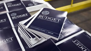 copies of a federal budget book on a table