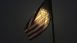 light shines through an American flag