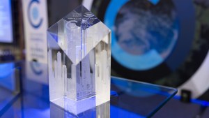 Glass Global Leadership Award on a table in front of the stage at the Global Leadership Awards Dinner. 