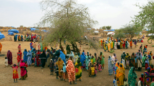 Sudanese displaced people gather at the Zam Zam refugee camp outside the town of El-Fashir in the Darfour region of Sudan on July 1, 2004.