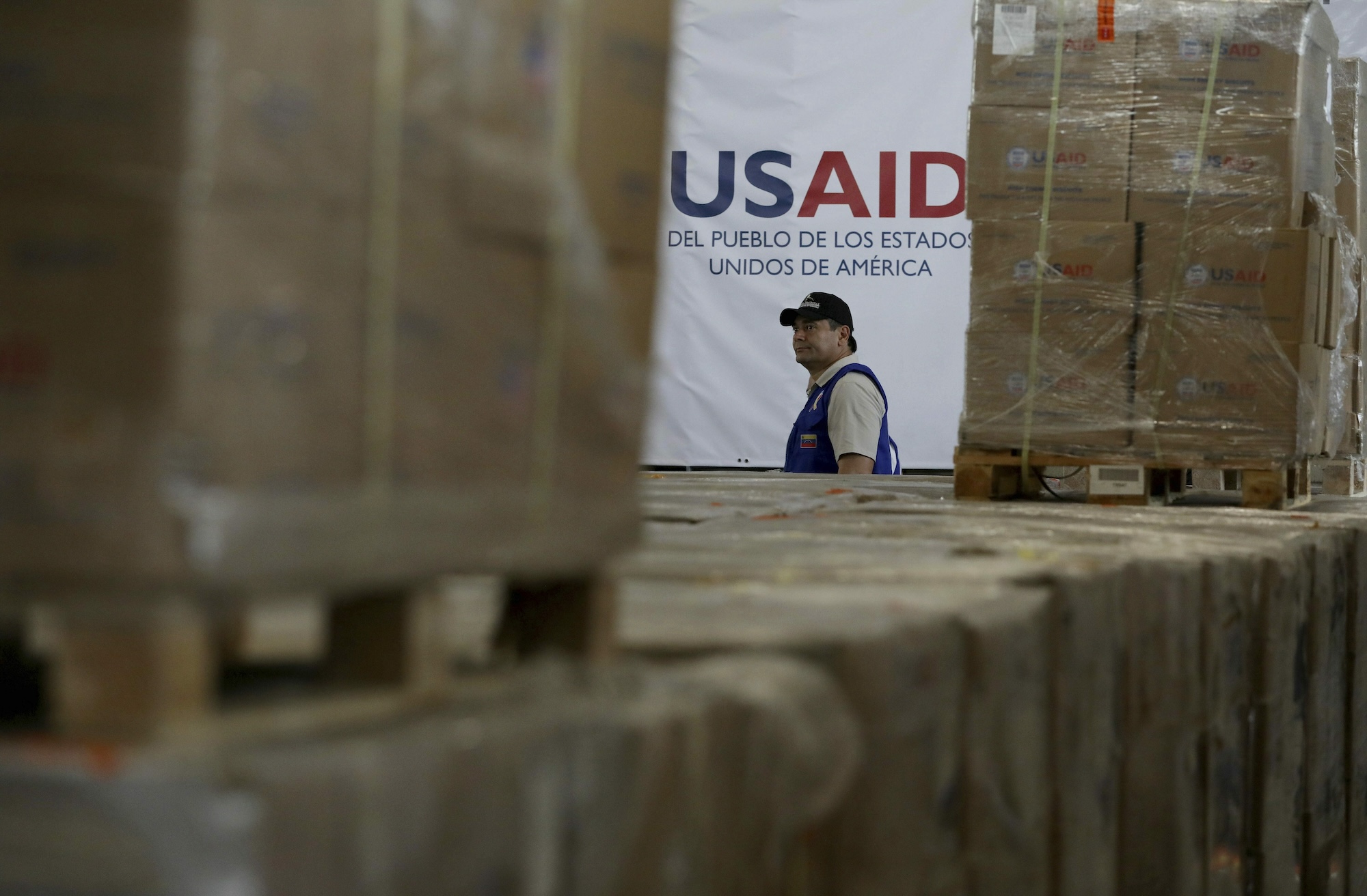 man standing behind boxes